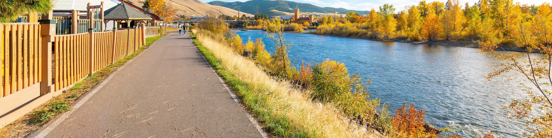 View from the Riverfront Trail along the Clark Fork River of the University District and tower of the Boone Crockett Club Natural History Museum in downtown Missoula, Montana.