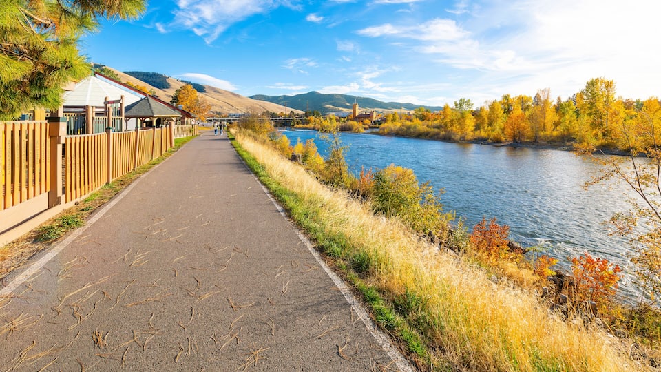 View from the Riverfront Trail along the Clark Fork River of the University District and tower of the Boone Crockett Club Natural History Museum in downtown Missoula, Montana.