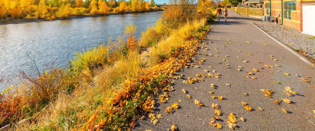 View from the Riverfront Trail walking path along the Clark Fork River at Caras Park of the University District in downtown Missoula, Montana.