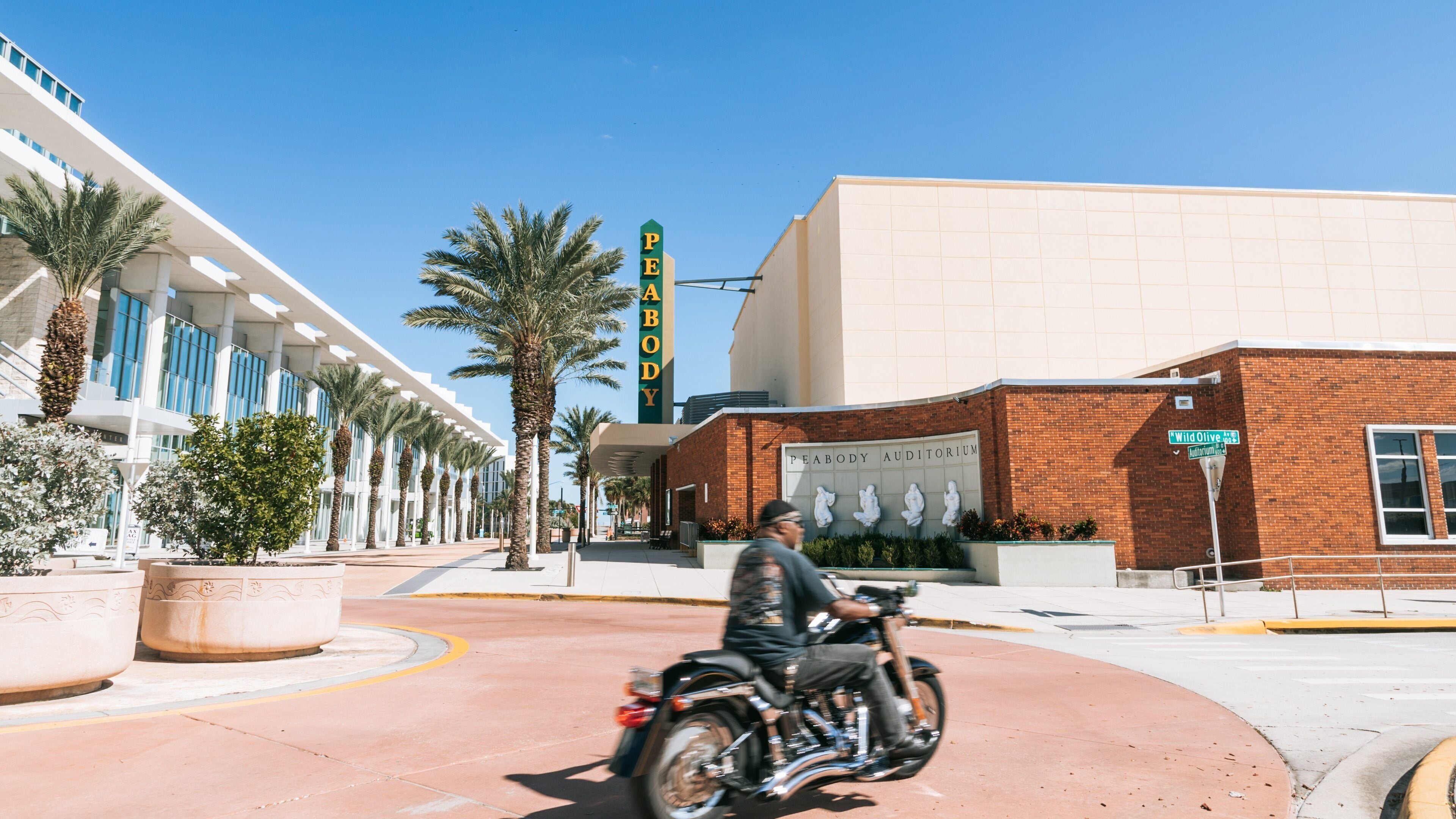 Peabody Auditorium featuring motorcycle riding as well as an individual male
