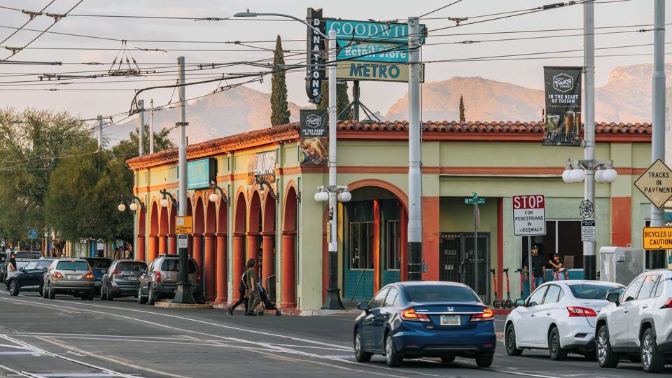 A street with cars, a Goodwill store, and a sign for the Fourth Avenue Historic District.