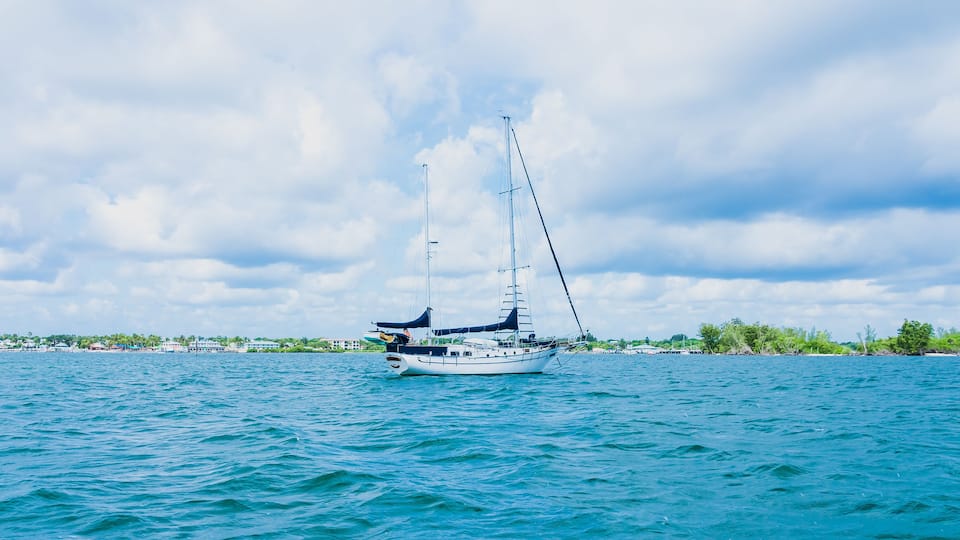 White moored yacht on the blue water of the Indian River in Florida in the city of Vero Beach in windy weather