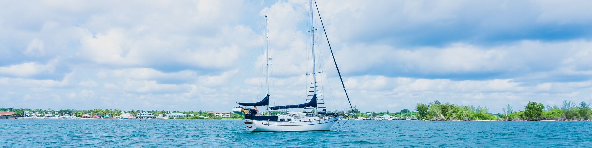 White moored yacht on the blue water of the Indian River in Florida in the city of Vero Beach in windy weather