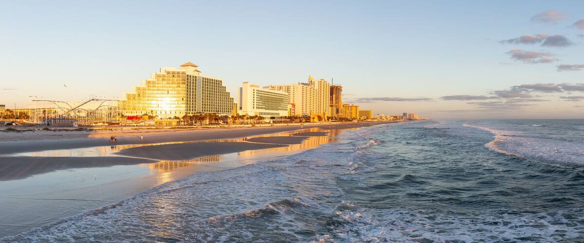 Daytona Beach, Florida, United States - October 31, 2018: Panoramic view of a beautiful sandy beach during a vibrant sunrise.