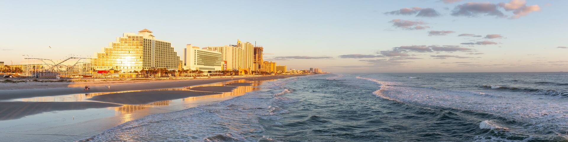 Daytona Beach, Florida, United States - October 31, 2018: Panoramic view of a beautiful sandy beach during a vibrant sunrise.