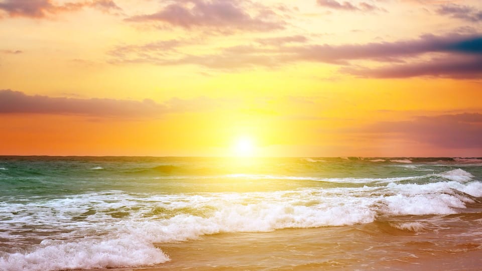 Colorful ocean beach sunrise. The concept is travel.