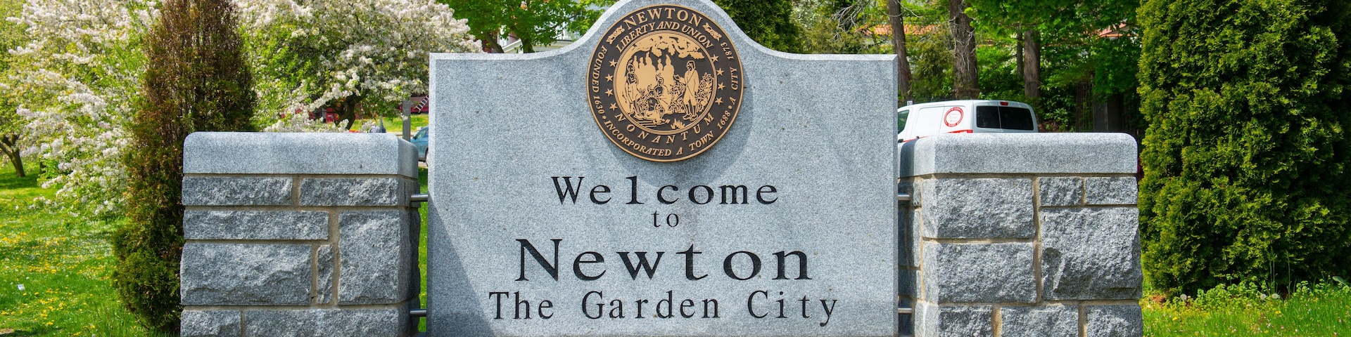 Welcome to Newton sign in spring on Commonwealth Avenue in Chestnut Hill, city of Newton, Massachusetts MA, USA.