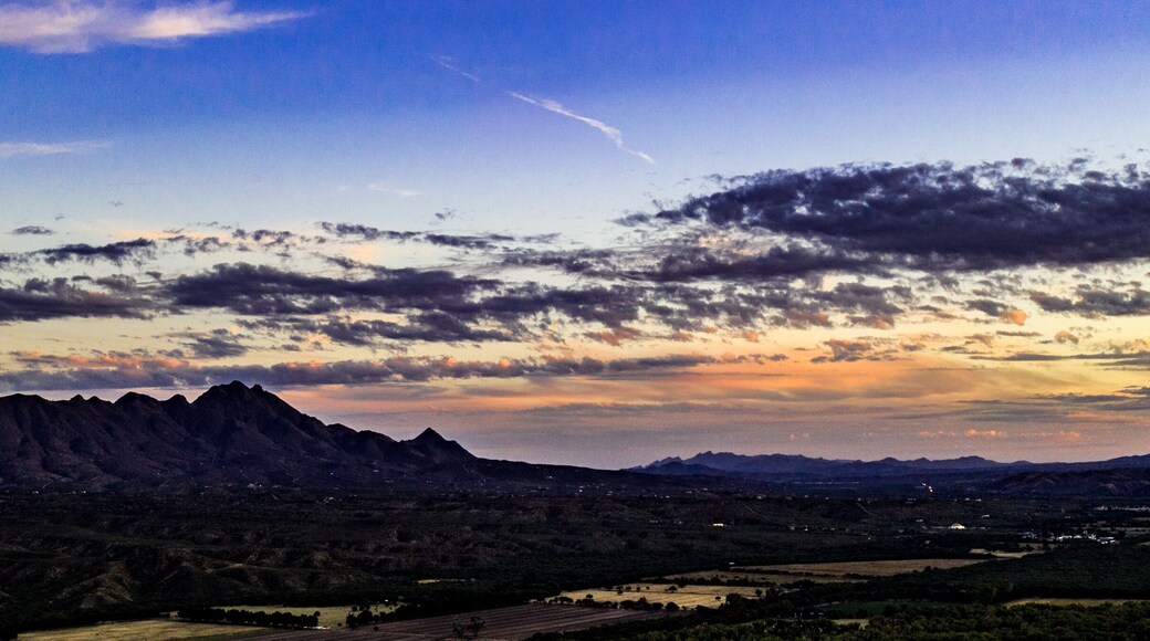 Sunset, aerial landscapes of Santa Rita Mountains from above Tubac, Arizona with warm , golden plains, purple mountains, blue sky with colorful clouds on a Fall day