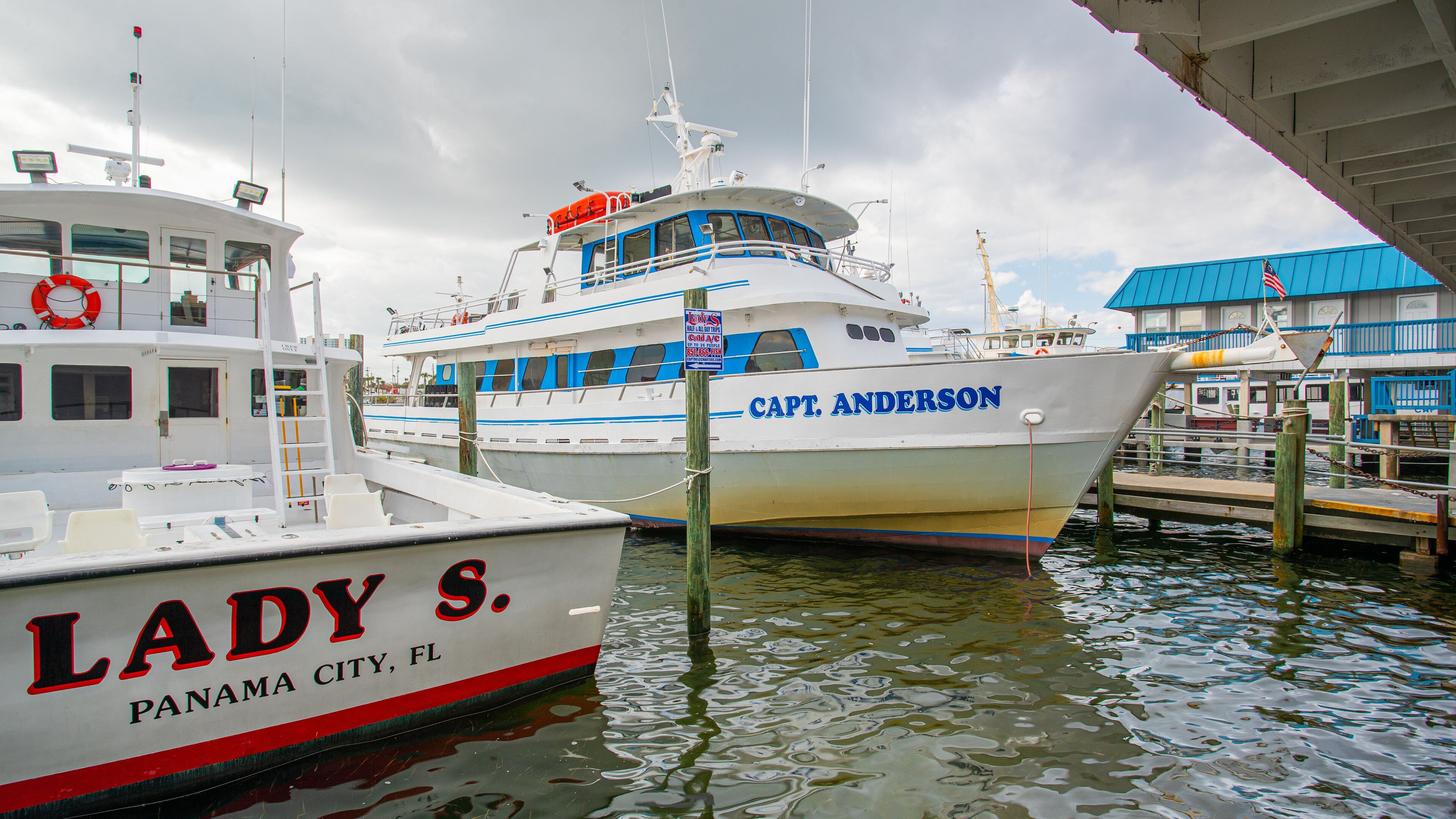 Port Lagoon which includes a bay or harbor and signage