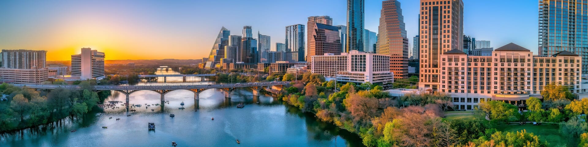 Austin, Texas- Panoramic cityscape and Colorado River against the sunset sky