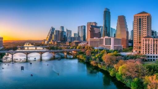 Austin, Texas- Panoramic cityscape and Colorado River against the sunset sky