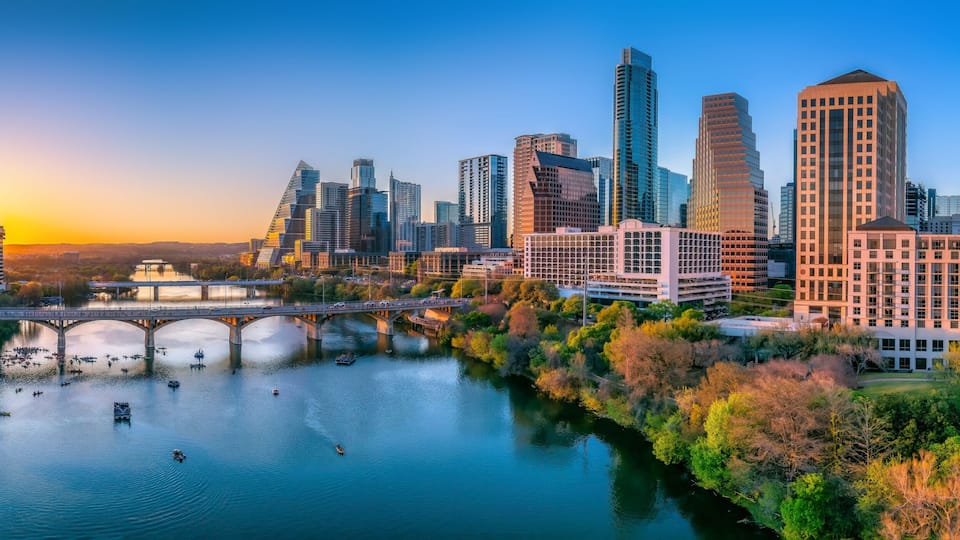 Austin, Texas- Panoramic cityscape and Colorado River against the sunset sky