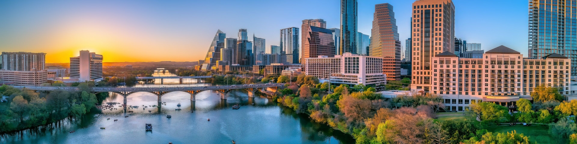 Austin, Texas- Panoramic cityscape and Colorado River against the sunset sky