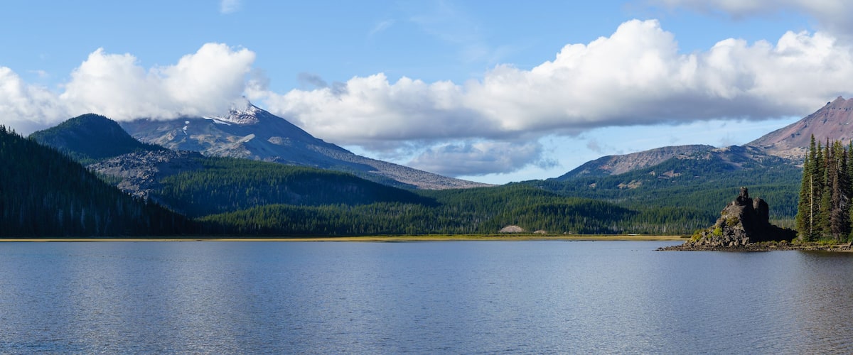 Clouds form above South Sisters and Broken Top as viewed from Sparks Lake, near Bend, Oregon.