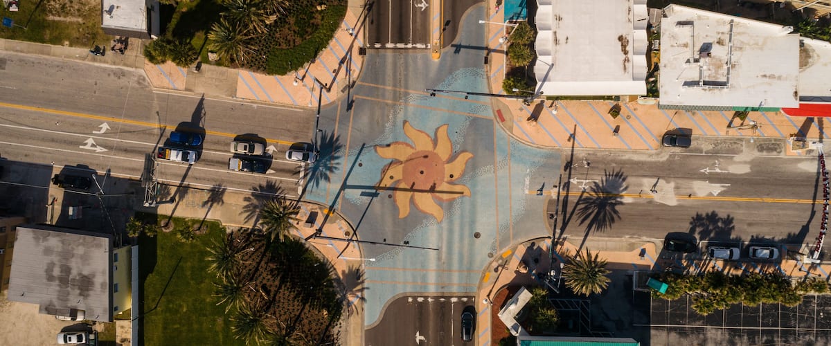"Daytona Beach, FL USA - 12-10-2020: Top-down drone shot of the iconic sun murals at the International Speedway intersection in Daytona Beach."