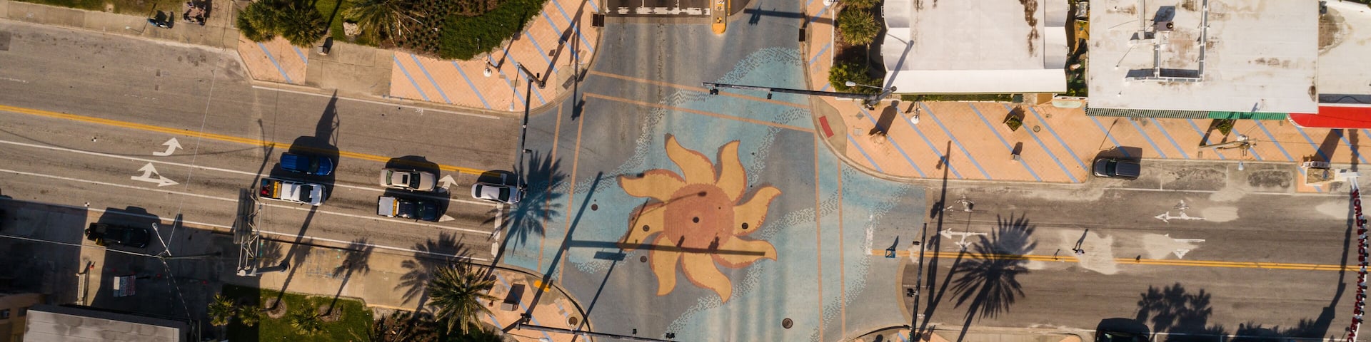 "Daytona Beach, FL USA - 12-10-2020: Top-down drone shot of the iconic sun murals at the International Speedway intersection in Daytona Beach."