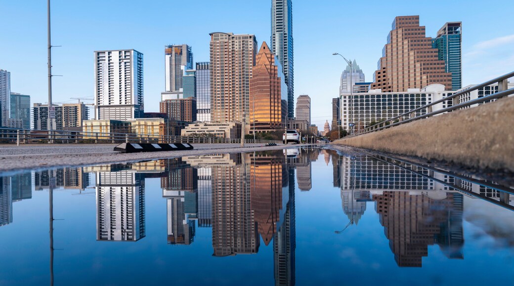 Vibrant Austin Texas city panoramic skyline, and modern buildings reflections on the rainwater over the Congress Avenue Bridge Road over the Lady Bird Lake in Colorado River
