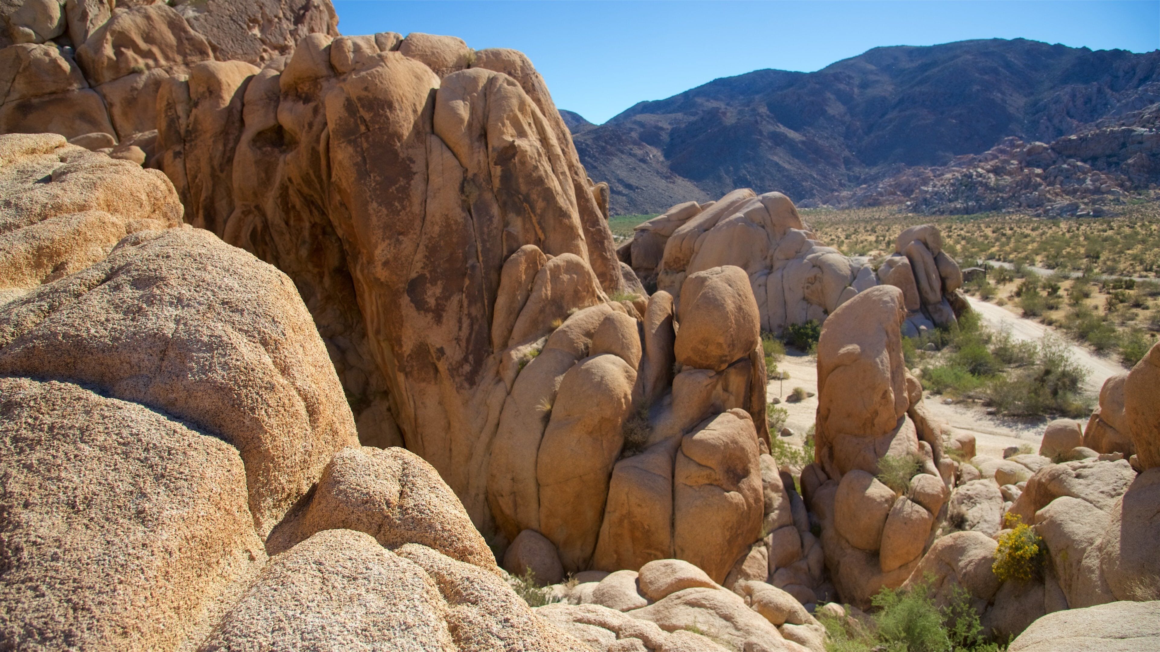 A rocky landscape with large boulders and a dirt path.