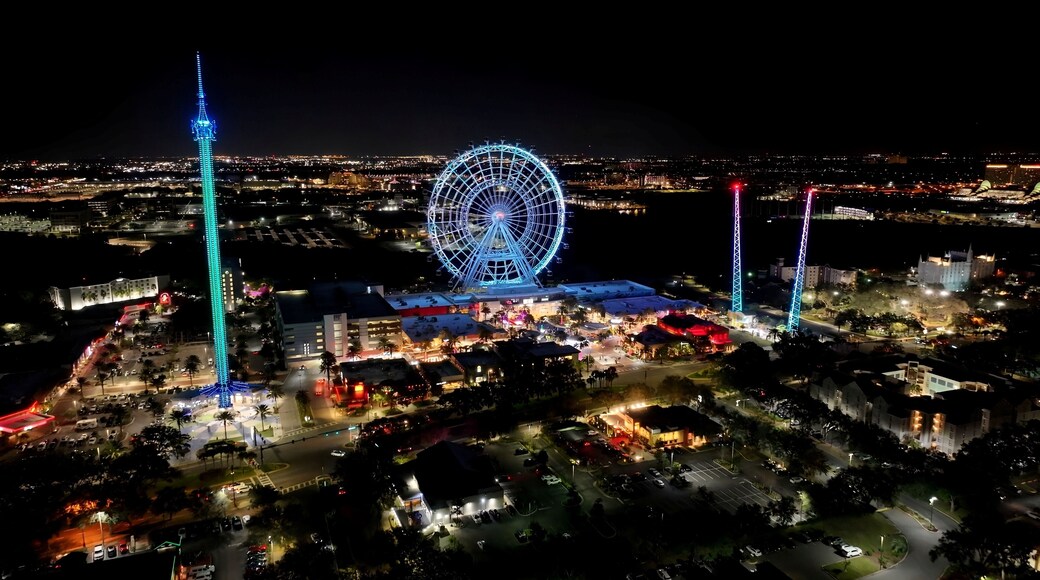 Night Illuminated Ferris Wheel In Orlando Florida United States. Breathtaking Aerial View Of Famous Ferris Wheel Of The City. Building Illuminated Urban. Town Up Above. City Landmark. Orlando Florida.