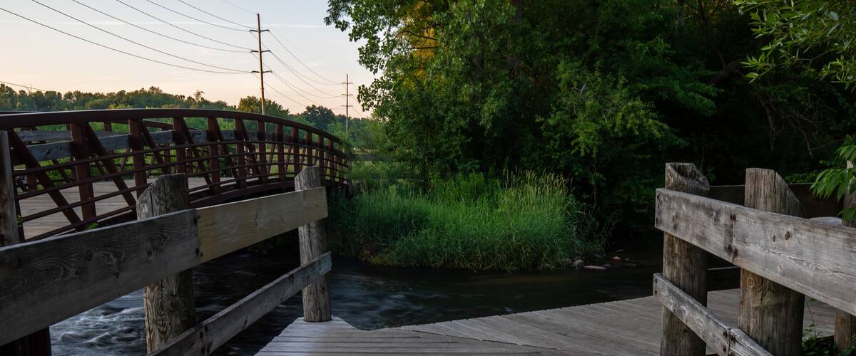 Wood deck over stream at portage creek bicentennial park in Michigan