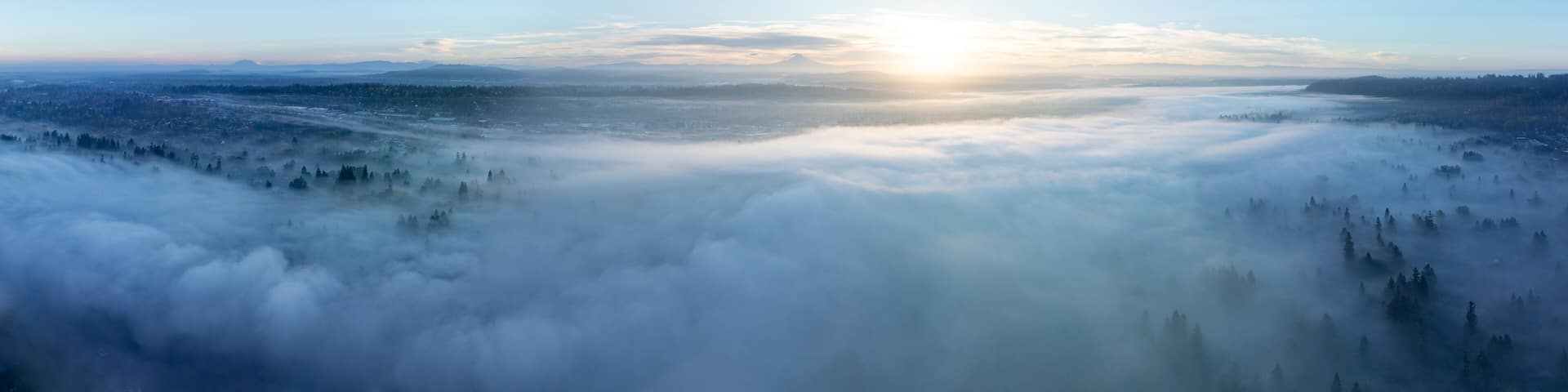 Early morning fog drifts through the Willamette Valley in West Linn, Oregon. This scenic area lies just south of the Pacific Northwest city of Portland.