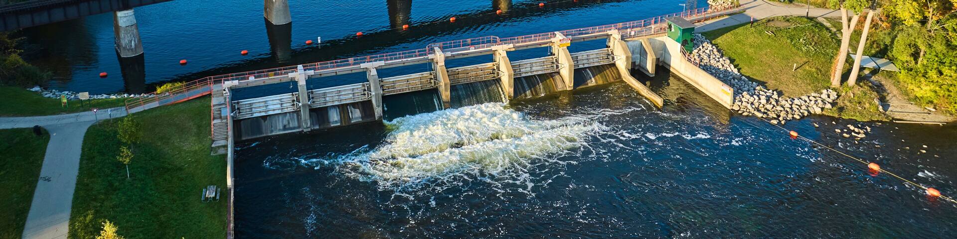 Aerial View of Railway Bridge and Dam on Huron River in Autumn