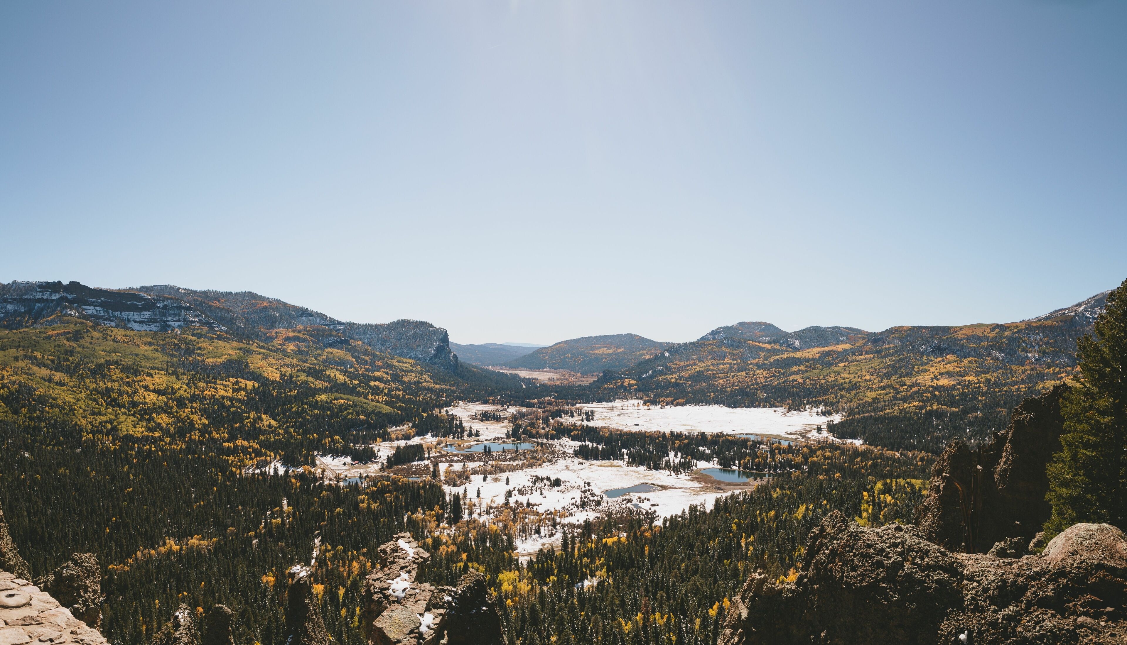 Beautiful landscape of a lake in a snowy forest in a mountainous area