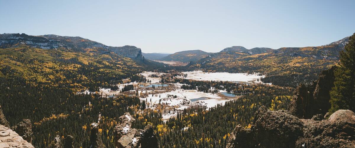 Beautiful landscape of a lake in a snowy forest in a mountainous area