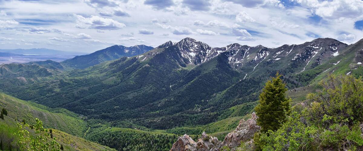 Rocky Mountain Wasatch Front peaks, panorama landscape view from Butterfield Canyon Oquirrh range toward Provo, Tooele Utah Lake by Rio Tinto Bingham Copper Mine, Great Salt Lake Valley in spring. Uta