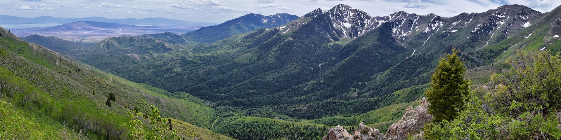 Rocky Mountain Wasatch Front peaks, panorama landscape view from Butterfield Canyon Oquirrh range toward Provo, Tooele Utah Lake by Rio Tinto Bingham Copper Mine, Great Salt Lake Valley in spring. Uta
