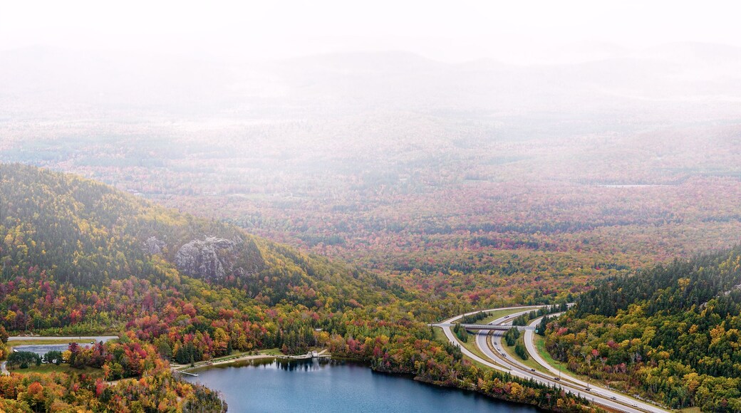 Franconia Notch State Park scenic view from Canon Mountain with Echo Lake and highway on foggy fall day