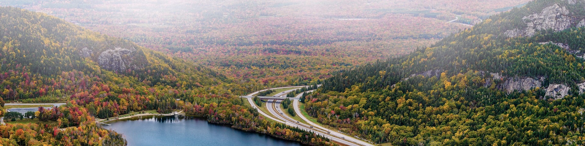 Franconia Notch State Park scenic view from Canon Mountain with Echo Lake and highway on foggy fall day