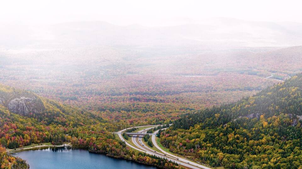 Franconia Notch State Park scenic view from Canon Mountain with Echo Lake and highway on foggy fall day