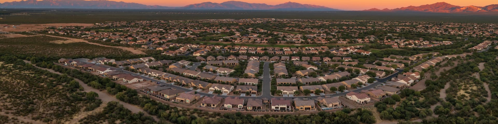 Quail Creek residential neighborhood in Sahuarita, aerial panorama at sunset