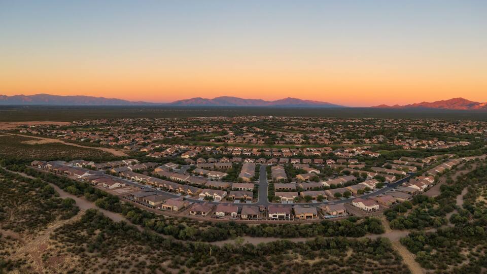Quail Creek residential neighborhood in Sahuarita, aerial panorama at sunset