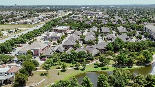 Panorama aerial view busy Keller Parkway along fast-growing area mixed of commercial buildings, residential houses, apartment complex in bursting green Keller, Texas, Dallas Fort Worth metroplex