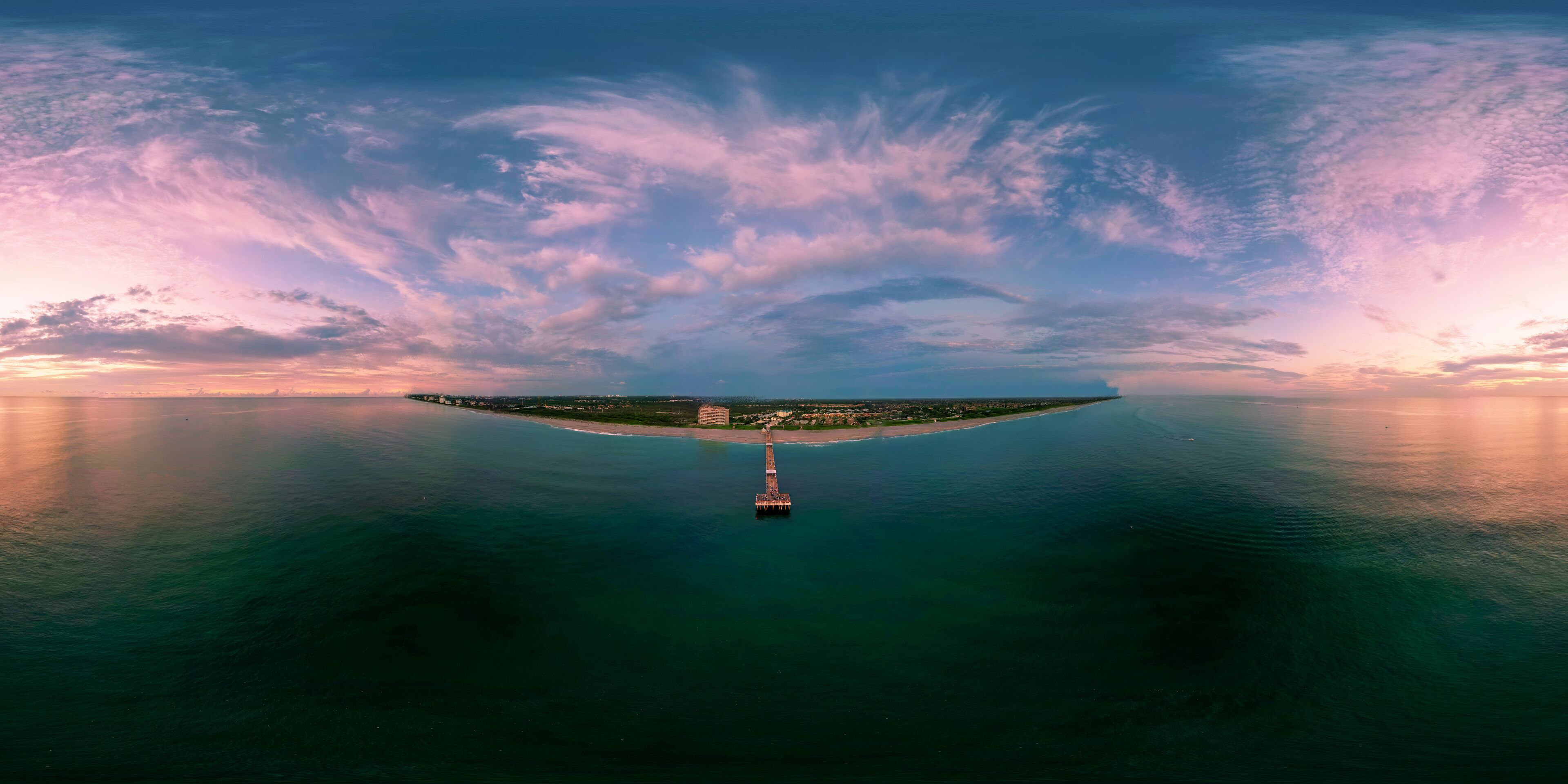 A 360 degree image of a colourful sunrise over Juno Beach, Florida, USA