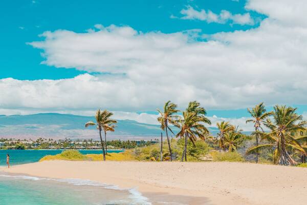 Hawaii beach panoramic travel banner of woman tourist walking on secluded shore in Waikoloa, Big Island, USA.