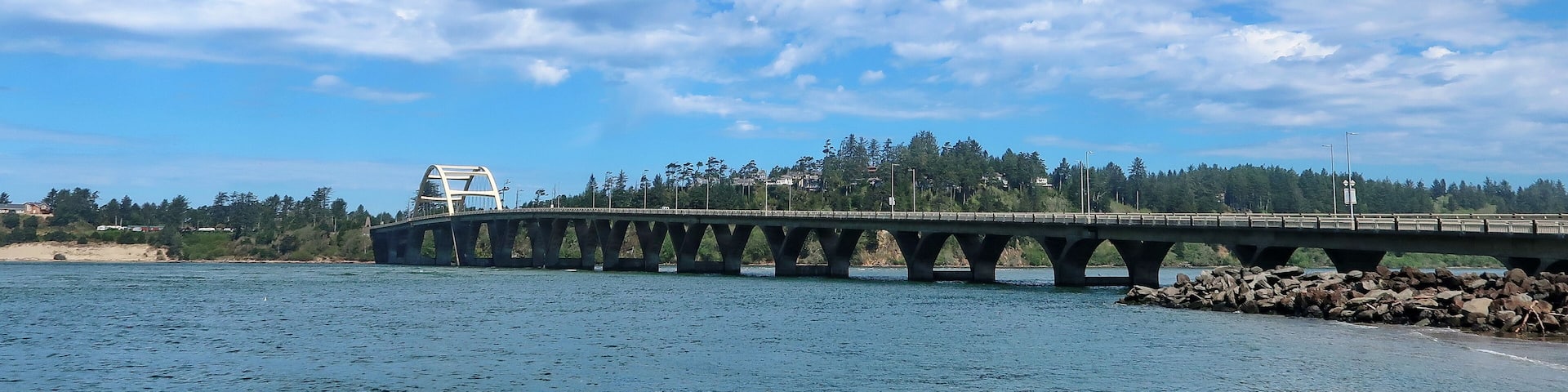 The Alsea Bay Bridge along coastal highway 101 connects Waldport and Bayshore on the Central Oregon Coast on a sunny spring day.