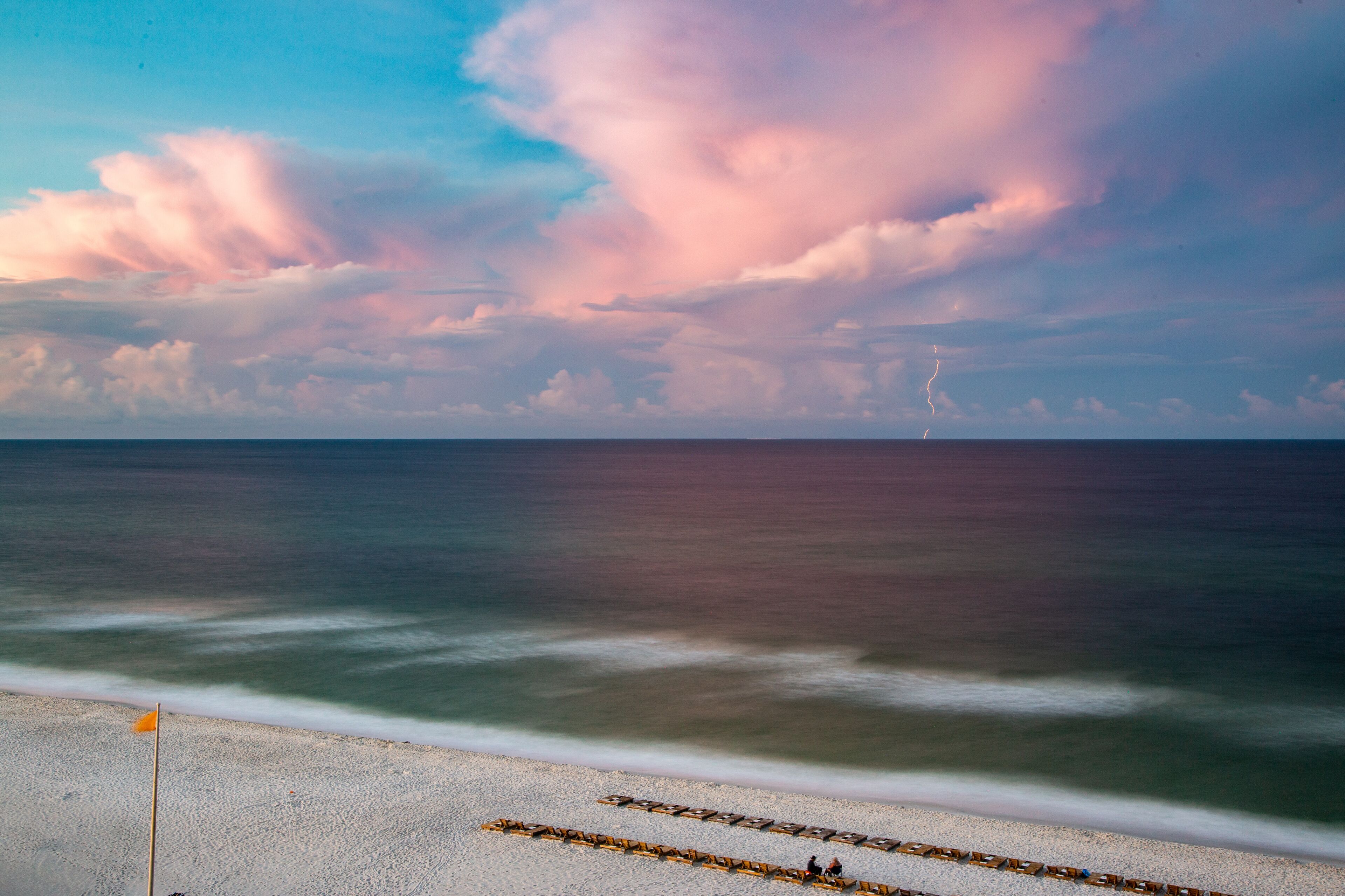 Long exposure sunrise by the beach with a lightning bolt