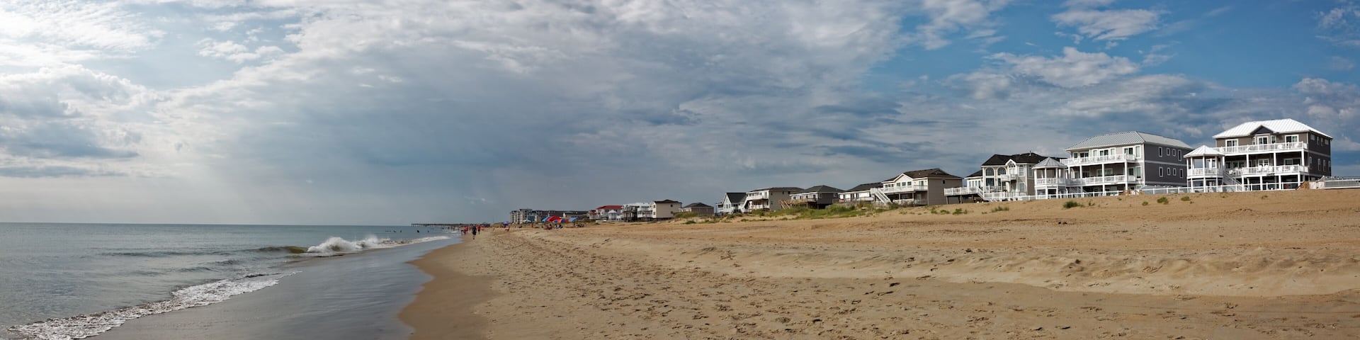 Outer Banks, North Carolina beach panorama. Sky, ocean, beach, and vacation rentals. Horizontal.
