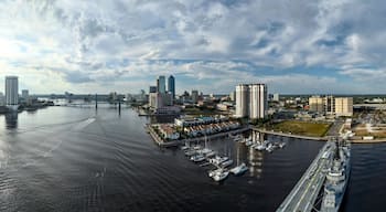 Aerial view of the St. Johns River reflecting the sunlight, cutting through the modern skyline and marina, Jacksonville, Florida, United States.