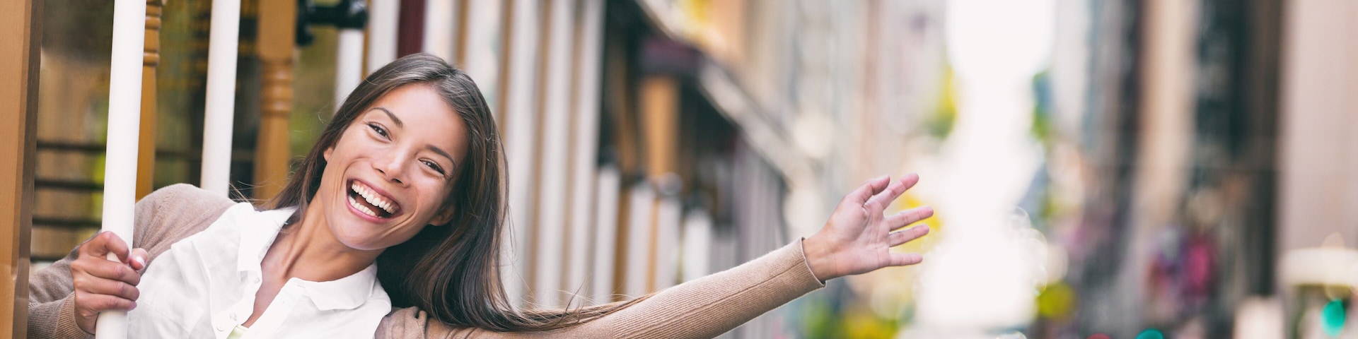 Happy excited Asian young student woman enjoying tram ride in San Francisco city panoramic banner waving hello free on public transport trolley. USA tramway travel panorama.