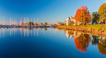 USA, Wisconsin. Panoramic view of Fall colors reflected on the still waters of the harbor in Bayfield on Lake Superior.