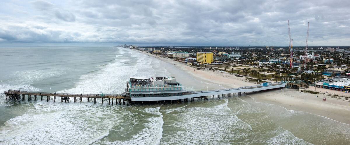 Pier reaching into the sea on Daytona Beach in Daytona, Florida, USA