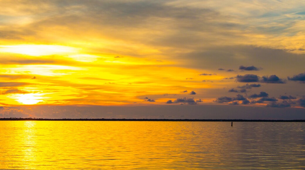 Dusk sunset above Gulf of Mexico ocean in Hudson Florida with orange sky