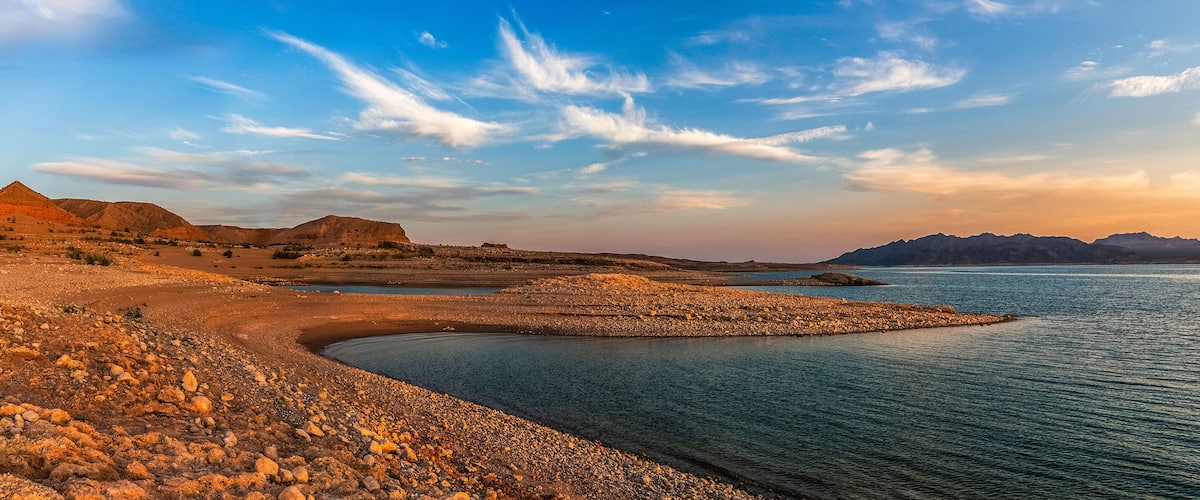 Beautiful panoramic landscape of the Lake Mead National Recreation Area from its muddy shore at sunset in summer, Nevada.