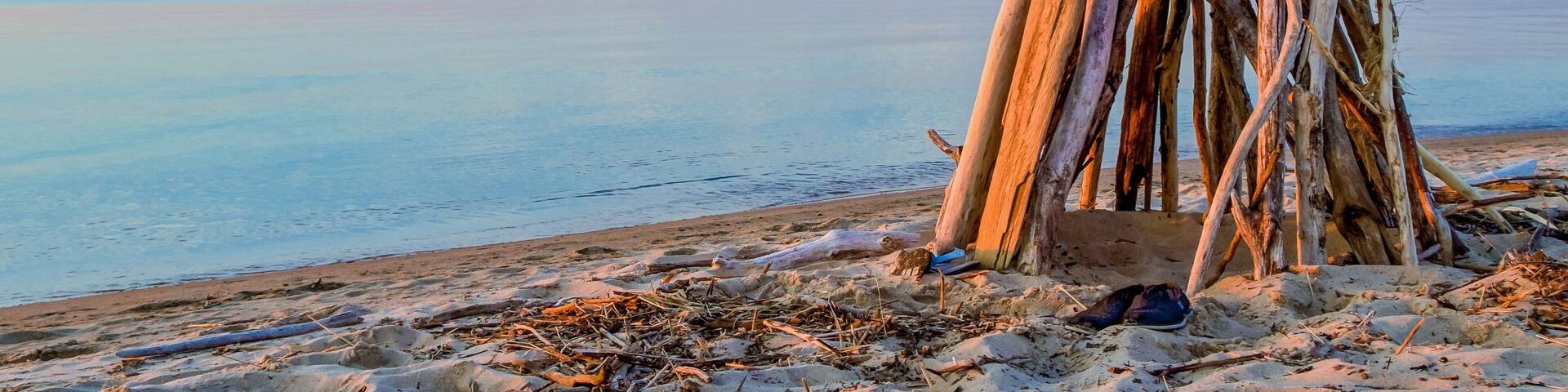 Welcome To The Beach. Driftwood beach hut with handwritten welcome sign. Port Crescent State Park. Port Austin, Michigan.