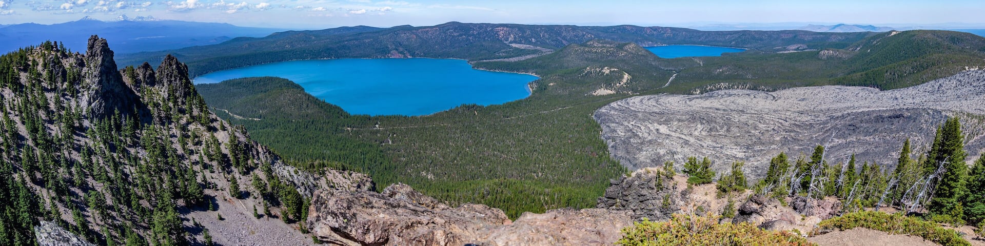 Scenic panorama image of Newberry volcano. View from Paulina Peak overlooking Paulina Lake, East Lake and Obsidian flow with Three Sisters on a horizon.