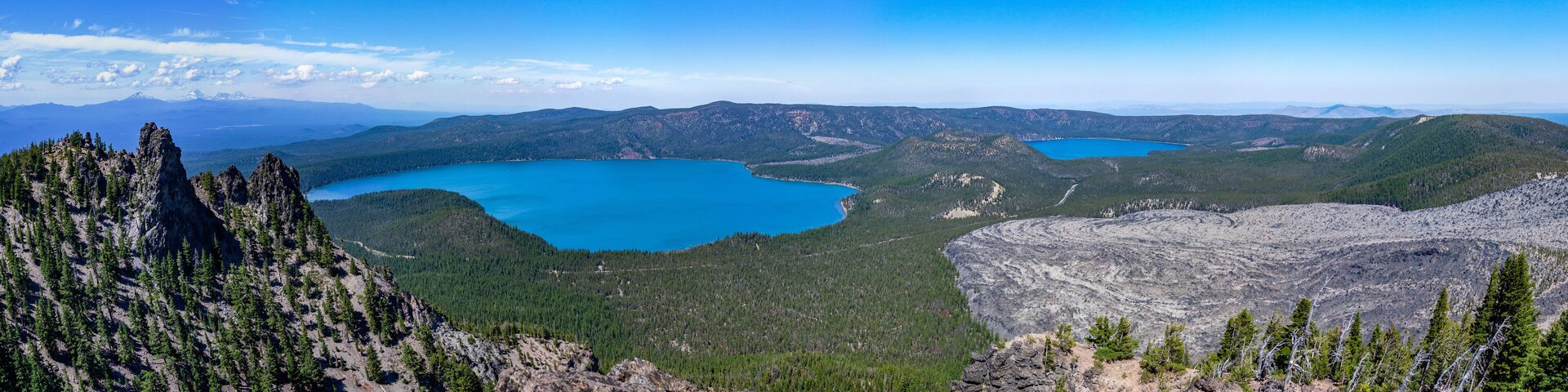 Scenic panorama image of Newberry volcano. View from Paulina Peak overlooking Paulina Lake, East Lake and Obsidian flow with Three Sisters on a horizon.